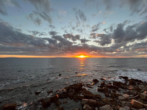 Sunset on a beach, with an orange colour. Very beautiful summer panorama. Golden hour.
