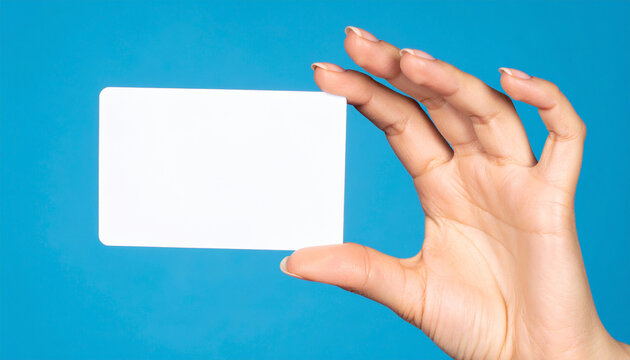 A person showing a blank business card held between a thumb and finger provides an empty paper space for a professional advertisement message or office communication note