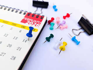 14th February marked on calendar page with blue push pin symbol valentine and romance and love and date and holiday and celebration