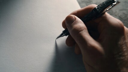 Hand with Pen Writing on Paper