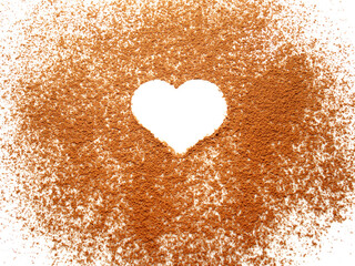 Heart shape on spreading cocoa powder