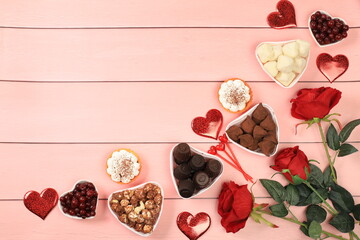 Gourmet heart shaped chocolate candies, sugar cranberry, meringue and rose flowers, food for Valentine's Day or Women's Day, greeting card, advertising banner or store invitation, selective focus.