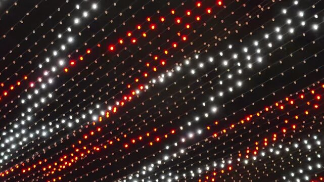 Mesmerizing sequences of overhead string lights for holiday shoppers at night