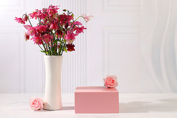 Abstract flower arrangement with empty podium for product display, template for display, Beautiful spring blooming columbine on sunny background, banner, still life with place for text,