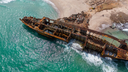 Aerial View of Rusted Shipwreck on Beach
