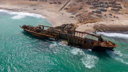 Aerial View of Rusted Shipwreck on Sandy Beach