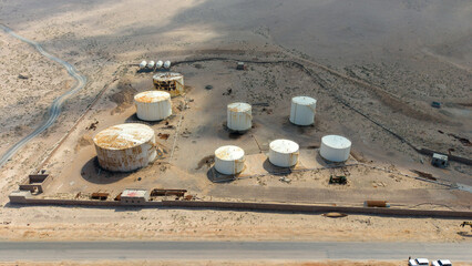 Abandoned Oil Storage Tanks in Desert Landscape