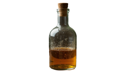 Glass bottle with cork filled with amber liquid on white background  