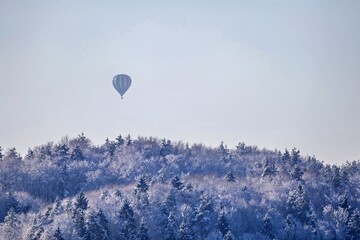 hot air balloon over the woodlands of franconian switzerland