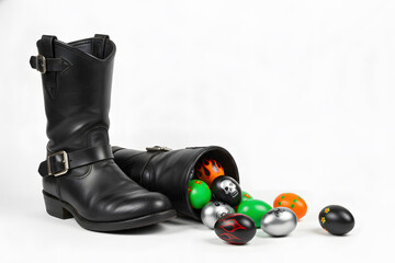 Black biker boots with decorated Easter eggs spilling out, alternative Easter banner with copy space on a white background