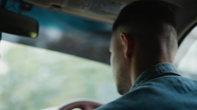 Driver examines GPS diligently, Urban delivery person focuses on map and vehicle controls, Caucasian driver wearing denim directs attention to GPS while monitoring surroundings attentively