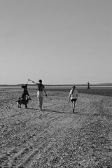 Two girls walking their dogs on the beach at Whiteford point on the Gower coast