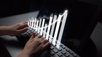 A close-up view of hands typing on a keyboard with digital graphs showcasing growth and data analytics, illustrating financial insights and business strategies. Copula