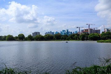 Fototapeta premium Panorama view of Jurong Lake with apartment towers of Taman Jurong Estate and cranes, Singapore
