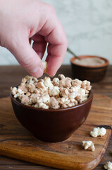 Protein popcorn in a ceramic bowl on a wooden background