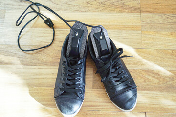 City walking shoes with an electric shoe dryer. Symbolizes bacteria control, urban foot care, health anxiety driven purchases, everyday routines, health education, and wellness equipment necessity.