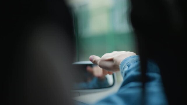 Car window scene, Person waving from car window with vendor reflection scene captured, Inside vehicle view showing passenger gesturing to street vendor with mirror and silhouette effects