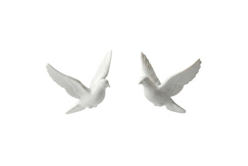 Two white ceramic doves in flight, transparent background