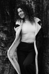 Fototapeta premium Woman with curly hair. Black and white portrait. Winter nature