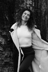 Fototapeta premium Woman with curly hair. Black and white portrait. Winter nature