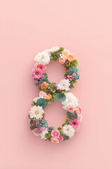 Floral arrangement shaped as the number eight, featuring a variety of colorful flowers on a soft pink background, creating a vibrant and cheerful atmosphere for celebrations