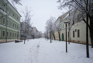 Cluj-Napoca/Romania. 1/07/2026: Snow covered city square with historic buildings during winter snowfall