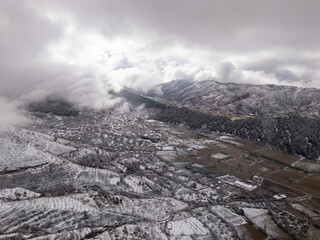Odemis valley village and fields under winter snow