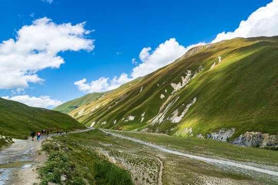 Summer hiking landscape with river, mountain, hills in Caucasus mountains. Kazbegi, Truso Gorge, in Georgia.