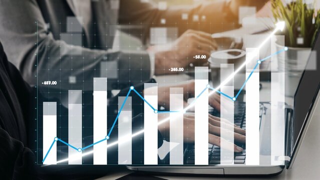 Engaging visual of business professionals analyzing growth metrics on a laptop, showcasing charts and graphs that represent data insights and trends in a meeting environment. Copula - Powered by Adobe