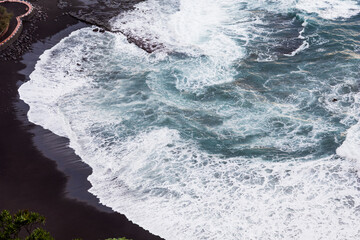 black sand beaches in Mesa de Mar, Tenerife, waves breaking and creating foam