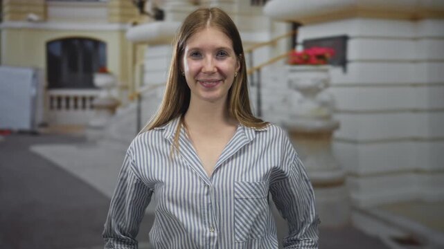 Woman smiles on street; confidence.