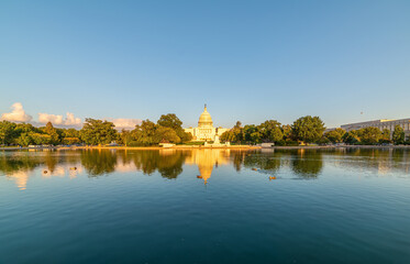 World famous United States Capitol Building reflected on the pool at sunset