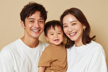 Fototapeta premium Happy family portrait with smiling parents and child