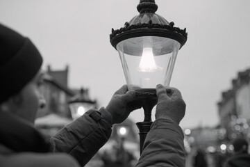 Adjusting street light in festive outdoor setting