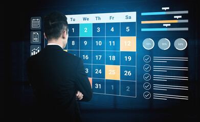 A business professional engages with a digital interactive calendar in a modern office, showcasing...
