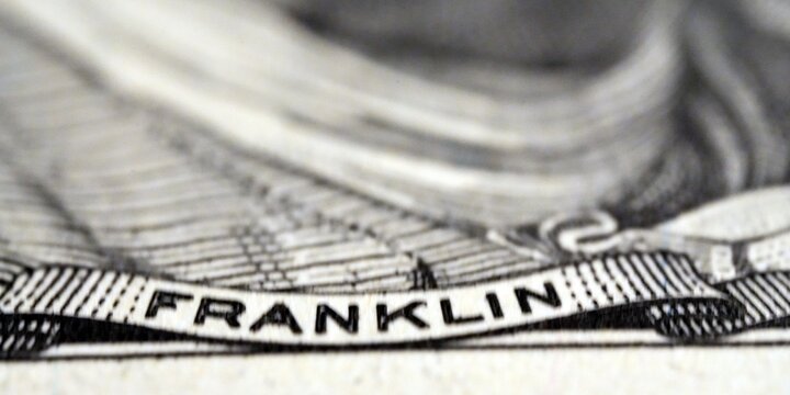 Close-up macro view of the name Franklin on a United States one hundred dollar bill. 