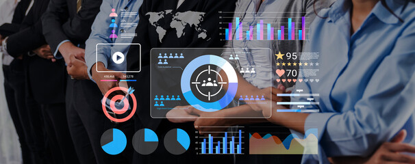 A diverse business team collaborates in a corporate setting, showcasing digital analytics and data visualization to enhance strategic decision-making and performance. Gantry