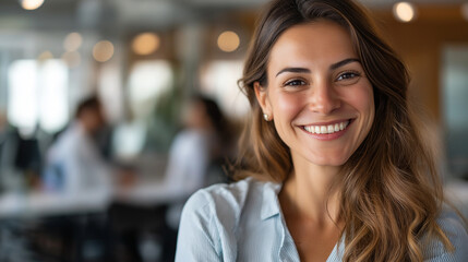 Naklejka premium Faceless smiling woman in business casual attire looking confident in well-lit office, defocused colleagues in background, with copy space