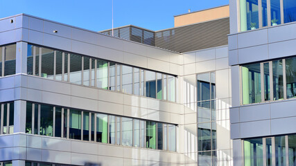 Modern facade of glass building. A modern contemporary office building with glass facade on a sunny day no people.