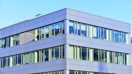 Modern facade of glass building. A modern contemporary office building with glass facade on a sunny day no people.