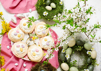 Easter meringue nests with whipped cream and decorative chocolate eggs