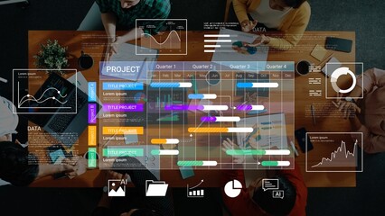 Creative teamwork and data analysis at a modern workspace showcasing project management with colorful charts and graphs overlaid on a wooden table Gluon.