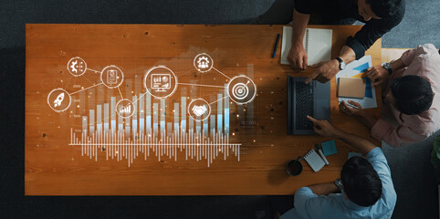A diverse team collaborates on business strategy, analyzing data through charts and graphs in a modern workspace, showcasing innovation and creativity. Trope