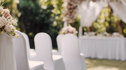 Elegant garden wedding ceremony setup featuring a floral arch and refined table arrangement