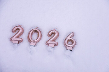 Minimal winter background featuring the year 2026 written on snow with empty space for text or design
