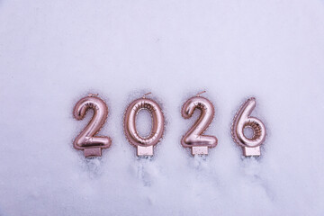 The numbers 2026 placed on snow, representing the upcoming year, winter season, and New Year concept