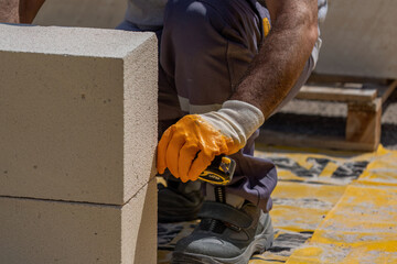 The bricklayer is working. Building a wall of aerated concrete. Gasbeton wall