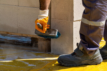 The bricklayer is working. Building a wall of aerated concrete. Gasbeton wall