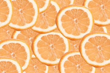 Orange slices background texture. Fresh citrus fruit pattern from above. Juicy orange cross sections filling the frame. Bright summer food backdrop with vitamin C concept and natural freshness.