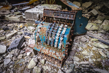 Rusted mechanical cash register in abandoned marketplace in Pripyat ghost town, Chernobyl Zone in Ukraine